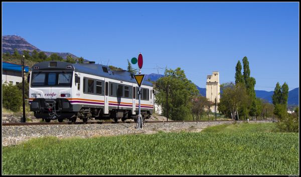sky,landscape,hill,grass,vehicle,train