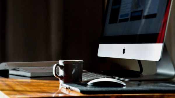 computer,imac,glasses,table,cup,writing
