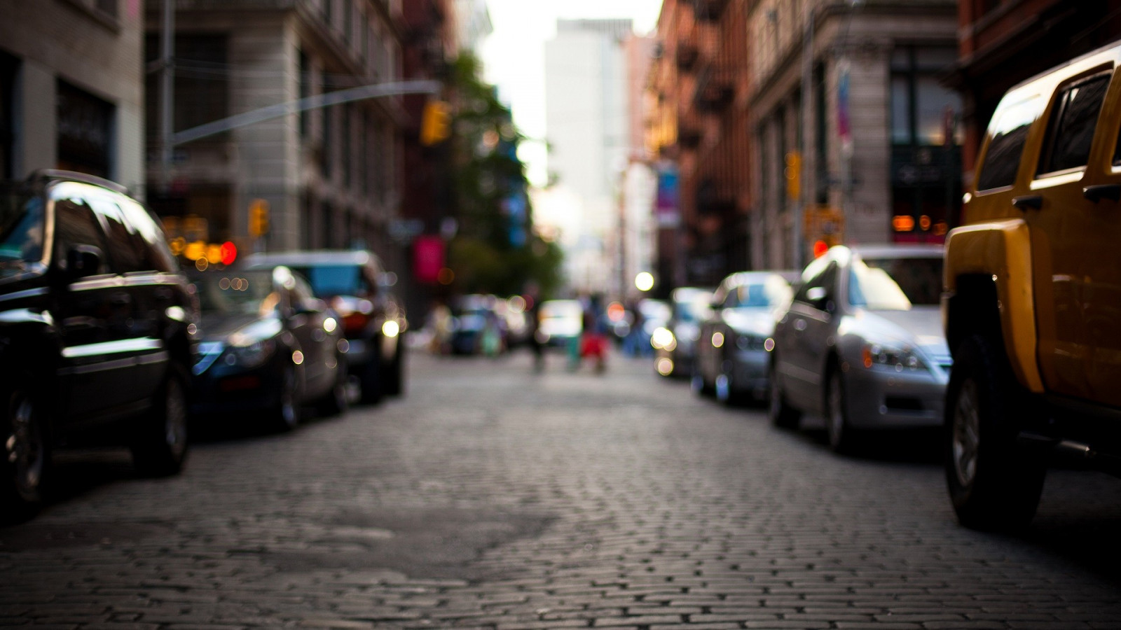 Wallpaper depth of field, city, street, night, cobblestone, vehicle