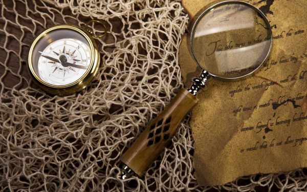 string,net,magnifying glass,compass,paper